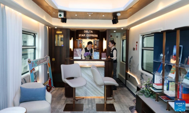 Staff members work aboard the Delta Star Express in Changzhou, east China's Jiangsu Province, May 19, 2026. The Delta Star Express, a tourist train featuring cozy accommodations, departed Tuesday from Shanghai, carrying nearly 200 passengers for an 18-day tour to northwest China's Xinjiang Uygur Autonomous Region. Developed by China Railway Shanghai Group Co., Ltd., the tourist train provides multi-passenger cabins with in-suite bathrooms, storage spaces as well as panoramic viewing windows. (Photo: Xinhua)
