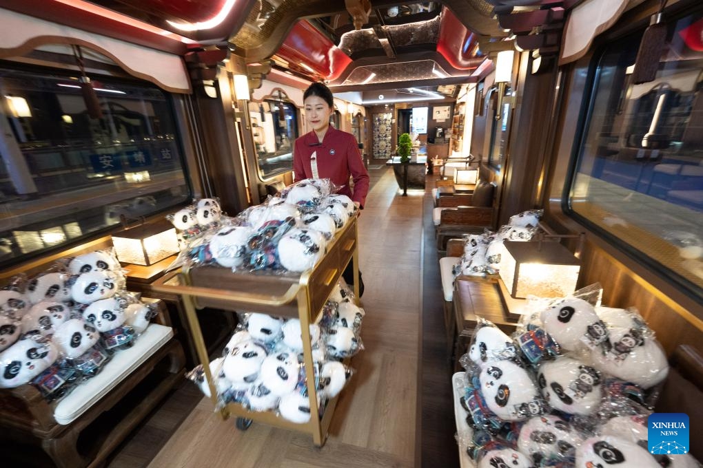 A crew member prepares stuffed toys as gifts for passengers on the panda train Splendid Tianfu, at Anjing Railway Station in southwest China's Sichuan Province, May 19, 2026. The panda train Splendid Tianfu, a panda-themed tourist train, departed Tuesday from Chengdu carrying 92 passengers for a 16-day tour of northwest China's Xinjiang Uygur Autonomous Region. (Photo: Xinhua)