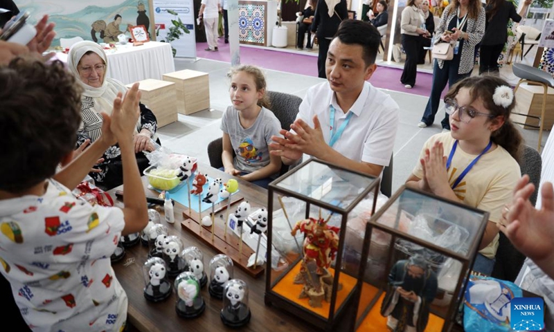 Visitors experience making handicrafts at the China Pavilion of the 25th International Tourism and Travel Fair (SITEV 2026) in Algiers, Algeria, on May 19, 2026. The event, held from May 18 to 21, serves as an important platform for showcasing the country's tourism resources and promoting tourism cooperation. (Photo: Xinhua)