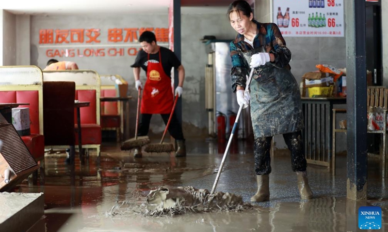 Workers clear mud at a restaurant in Duyun City, southwest China's Guizhou Province, May 19, 2026. Heavy rains lashed Duyun City from 6 a.m. Monday to 6 a.m. Tuesday. Flood control and disaster relief work are underway in flood-hit areas. (Photo: Xinhua)