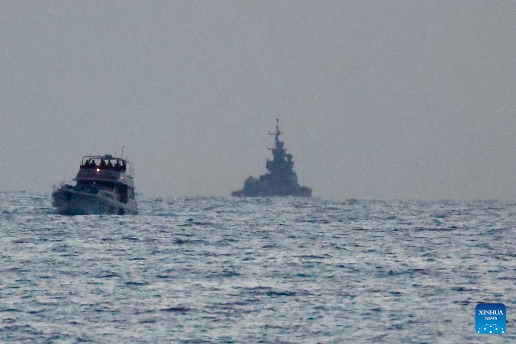 A boat of the Gaza-bound aid flotilla (L), after being intercepted by the Israeli navy, is escorted toward the Israeli port of Ashdod, Israel, on May 19, 2026. Israel said late Tuesday that it had intercepted all boats in a Gaza-bound aid flotilla, detaining hundreds of activists and transporting them to Israel. (Photo: Xinhua)