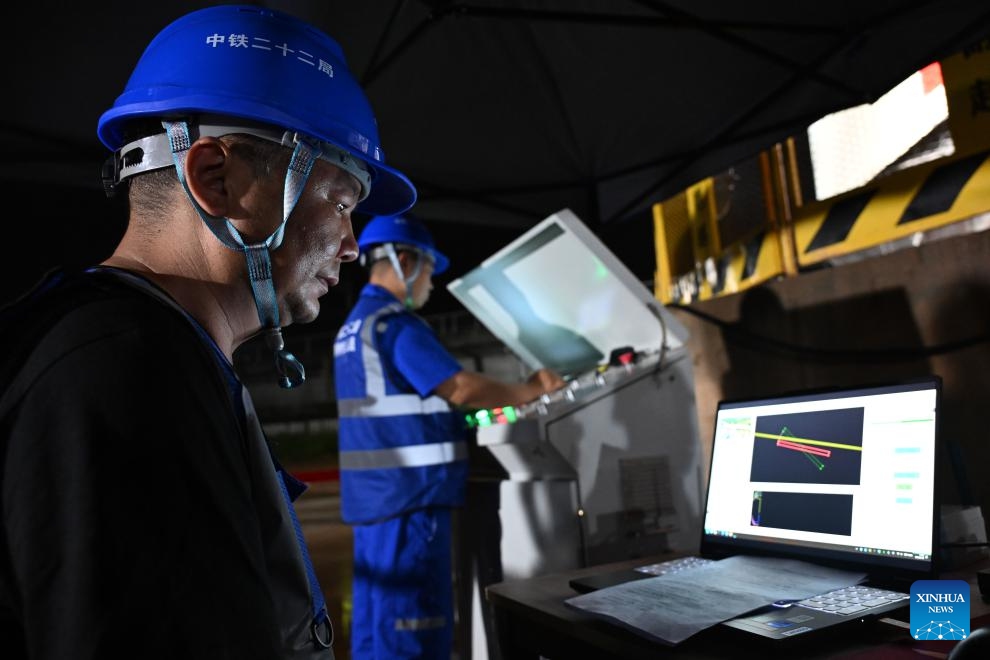 Staff members monitor the rotation process of the continuous beam of the Xijiang River Grand Bridge in Zhaoqing, south China's Guangdong Province, on May 19, 2026. A continuous beam of the Xijiang River Grand Bridge completed its rotation on Tuesday, crossing two existing high-speed railways. The 8,324-meter bridge is a key project of the Zhuhai-Zhaoqing high-speed railway under construction. The railway is expected to improve transport links in the Guangdong-Hong Kong-Macao Greater Bay Area. (Photo: Xinhua)