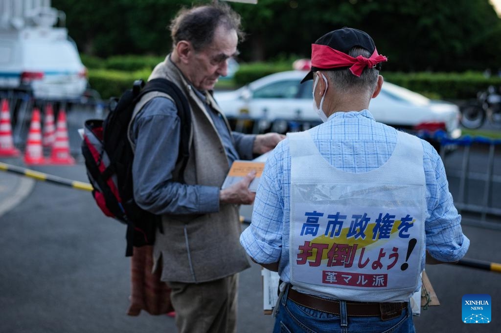 A man wearing clothes with slogans participates in a protest rally in front of the National Diet Building in Tokyo, Japan, May 19, 2026. Thousands of demonstrators gathered in front of Japan's National Diet Building in Tokyo on Tuesday evening to protest the government's attempts to undermine the country's pacifist constitution through constitutional revision and military expansion policies. (Photo: Xinhua)