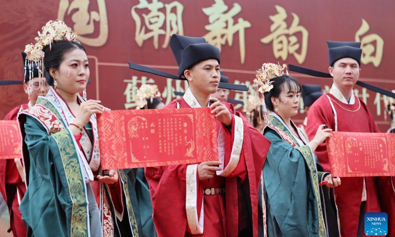 Newlyweds participate in a group wedding in Jizhou District, north China's Tianjin, May 20, 2026. A group wedding ceremony, combining traditional Chinese cultural charm with a new civilized trend, was held here on Wednesday. Fourteen newly married couples in traditional Chinese costumes attended the group wedding following traditional wedding rituals while embodying the positive spirit of new-style practices. (Photo: Xinhua)