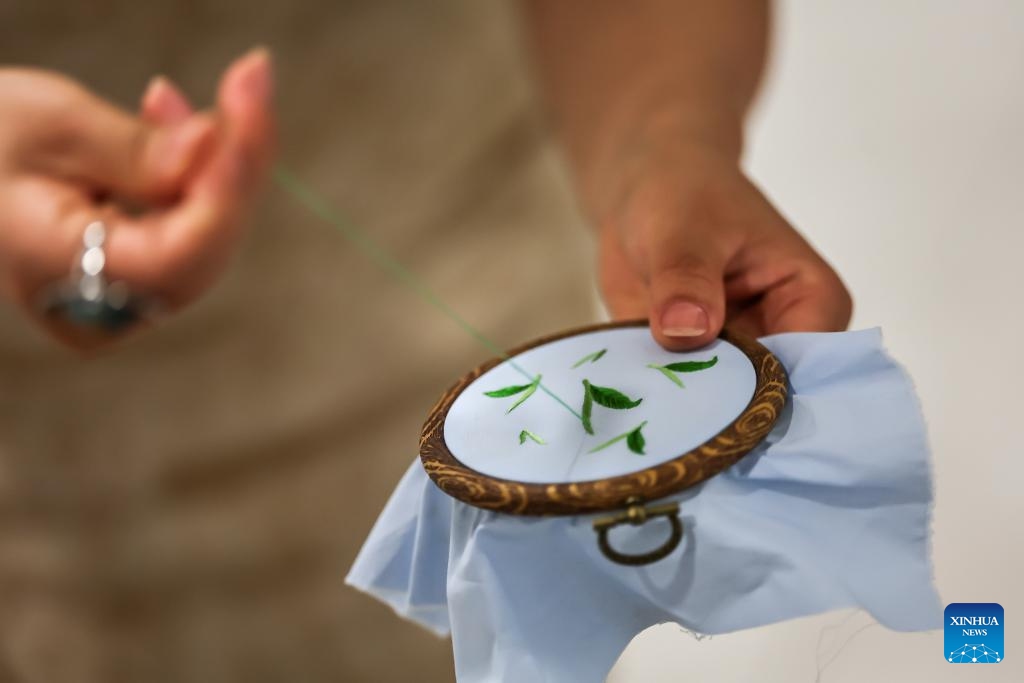 A Chinese artisan demonstrates her embroidery skills during a Chinese tea cultural event in Budapest, Hungary, on May 19, 2026. A Chinese tea cultural event themed Tea: The Taste of Harmony was held Tuesday in Budapest to promote cultural exchanges between China and Hungary through traditional tea ceremonies and artistic performances. (Photo: Xinhua)