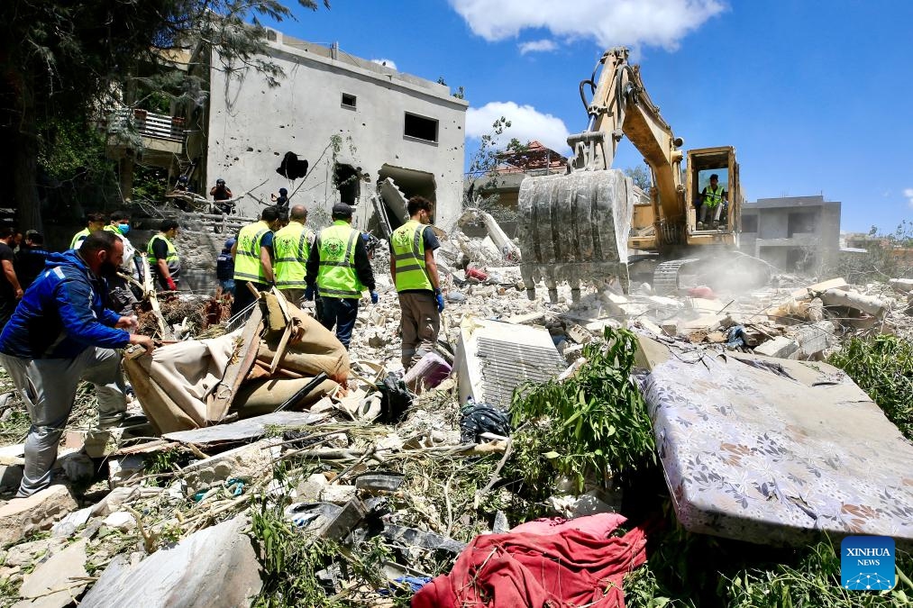 Rescuers search through the rubble for three people reported missing at the scene of an Israeli airstrike in Deir Qanoun En Nahr, near the southern Lebanese city of Tyre, on May 20, 2026. Israeli airstrikes across southern Lebanon overnight into Wednesday killed at least 29 people, including women and children, and wounded dozens more, according to the state-run National News Agency (NNA). (Photo: Xinhua)