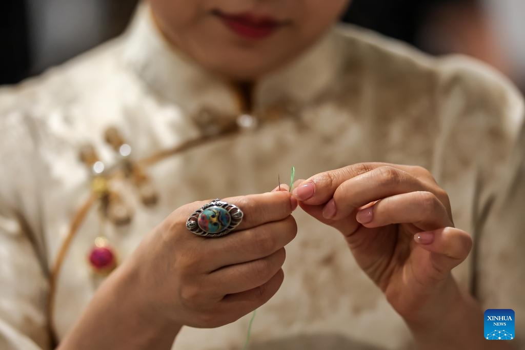 A Chinese artisan demonstrates her embroidery skills during a Chinese tea cultural event in Budapest, Hungary, on May 19, 2026. A Chinese tea cultural event themed Tea: The Taste of Harmony was held Tuesday in Budapest to promote cultural exchanges between China and Hungary through traditional tea ceremonies and artistic performances. (Photo: Xinhua)