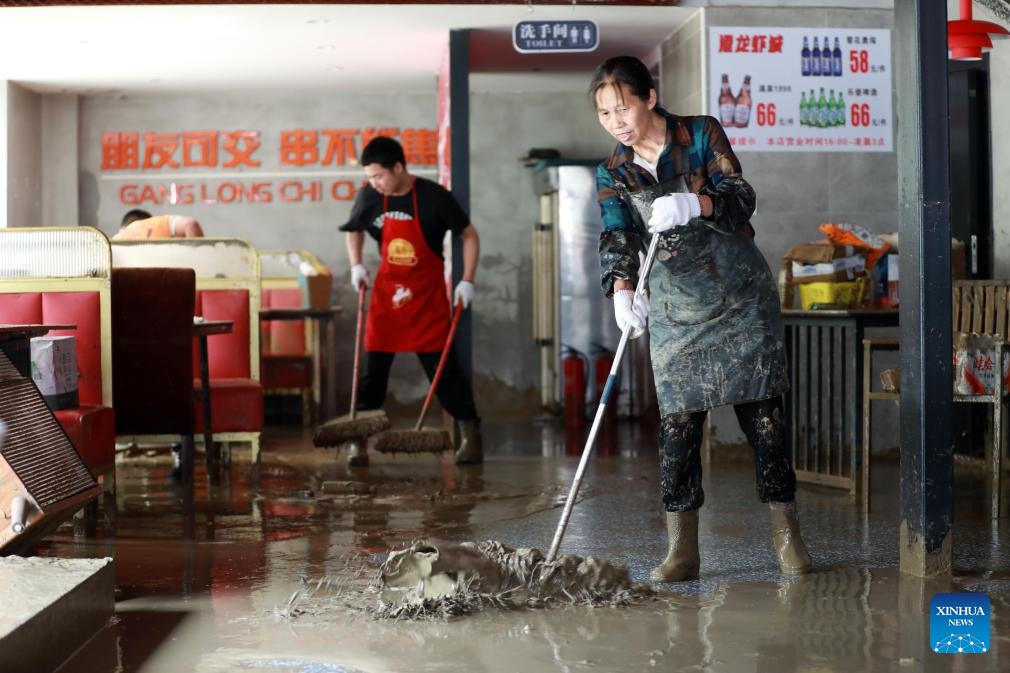 Workers clear mud at a restaurant in Duyun City, southwest China's Guizhou Province, May 19, 2026. Heavy rains lashed Duyun City from 6 a.m. Monday to 6 a.m. Tuesday. Flood control and disaster relief work are underway in flood-hit areas. (Photo: Xinhua)
