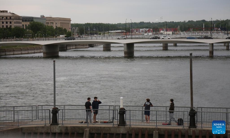 People fish by Des Moines River in Des Moines, Iowa, the United States, on May 14, 2026. (Photo: Xinhua)