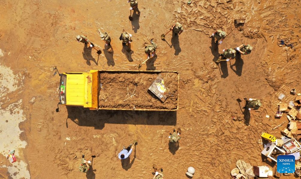 An aerial drone photo shows people clearing mud at a community in Duyun City, southwest China's Guizhou Province, May 19, 2026. Heavy rains lashed Duyun City from 6 a.m. Monday to 6 a.m. Tuesday. Flood control and disaster relief work are underway in flood-hit areas. (Photo: Xinhua)