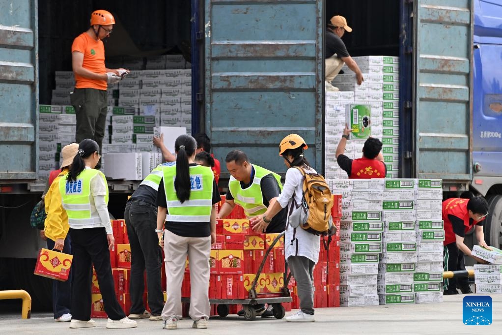 Staff members unload disaster relief supplies from trucks at a temporary relocation site in Liuzhou, south China's Guangxi Zhuang Autonomous Region, May 19, 2026. Two earthquakes of 5.2-magnitude struck Liuzhou City in quick succession, causing casualties and damaging buildings. Multiple temporary relocation sites have been set up with sufficient relief supplies and medical services for quake-affected residents. (Photo: Xinhua)