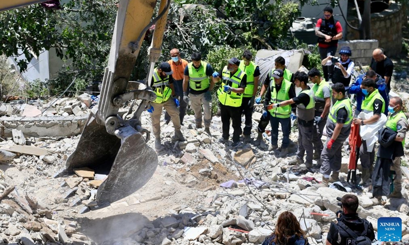 Rescuers search through the rubble for three people reported missing at the scene of an Israeli airstrike in Deir Qanoun En Nahr, near the southern Lebanese city of Tyre, on May 20, 2026. Israeli airstrikes across southern Lebanon overnight into Wednesday killed at least 29 people, including women and children, and wounded dozens more, according to the state-run National News Agency (NNA). (Photo: Xinhua)