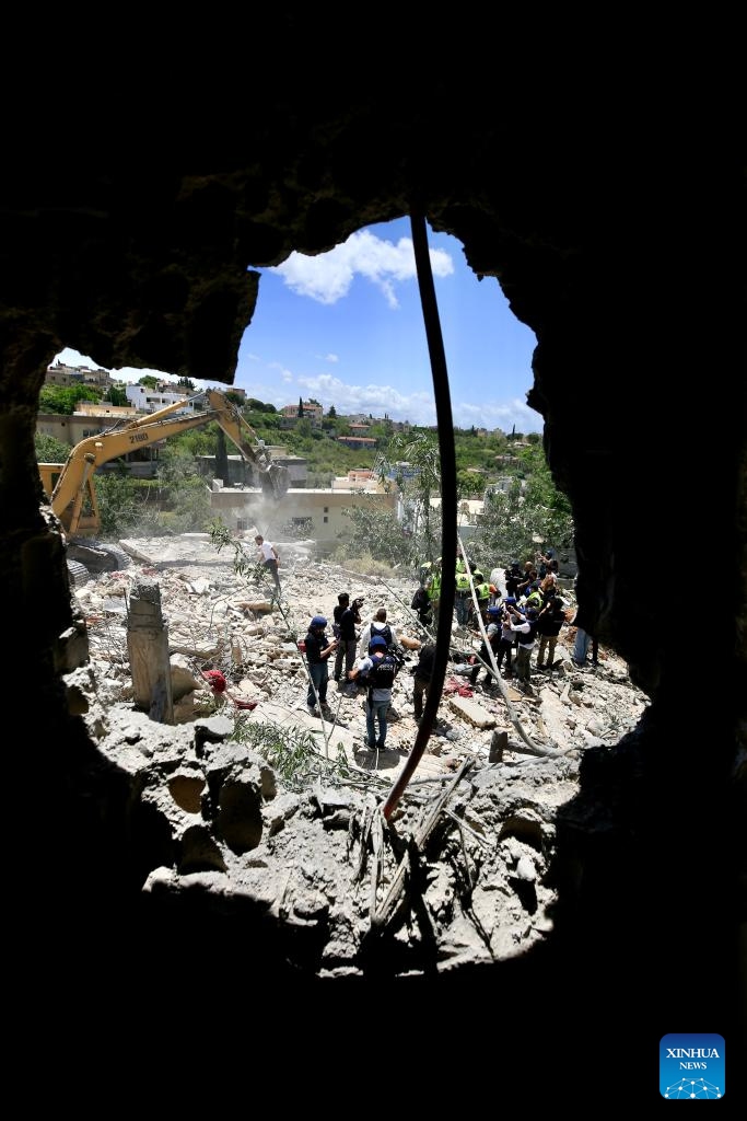 Rescuers search through the rubble for three people reported missing at the scene of an Israeli airstrike in Deir Qanoun En Nahr, near the southern Lebanese city of Tyre, on May 20, 2026. Israeli airstrikes across southern Lebanon overnight into Wednesday killed at least 29 people, including women and children, and wounded dozens more, according to the state-run National News Agency (NNA). (Photo: Xinhua)