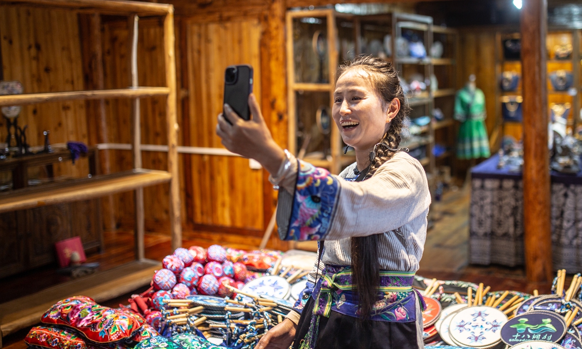 Wu Xiuman, a tour guide, livestreams at the Miao embroidery exhibition center in Shibadong village, Xiangxi Tujia and Miao Autonomous Prefecture in Central China's Hunan Province, on May 7, 2026. Photo: Shan Jie/GT