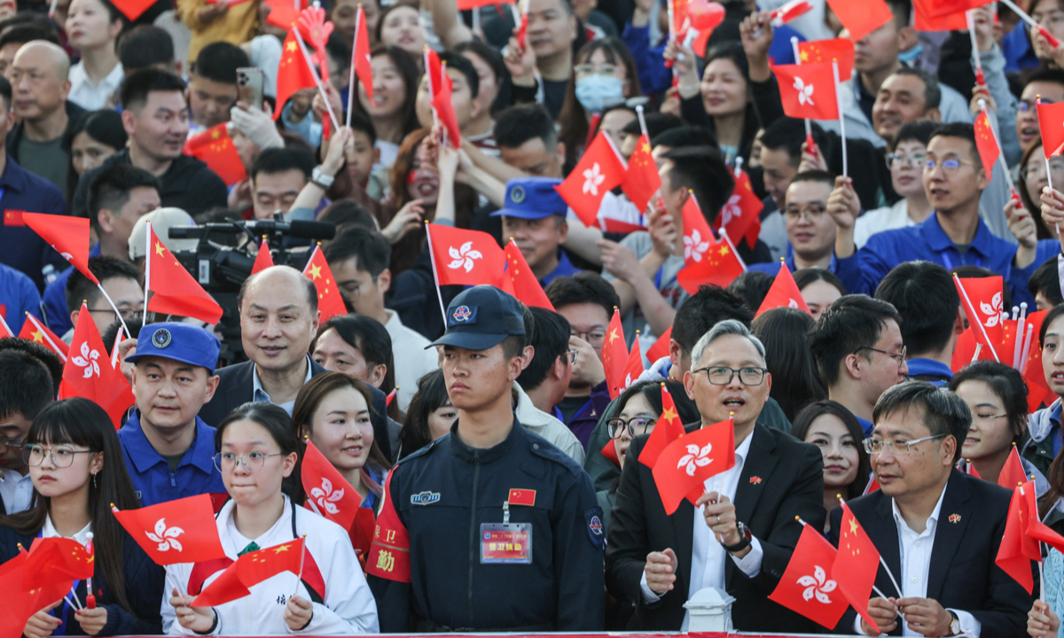 Spectators wave the national flag and the Hong Kong Special Administrative Region flag at the send-off ceremony for the three Chinese astronauts of the Shenzhou-23 crewed space mission at the Jiuquan Satellite Launch Center in northwest China on May 24, 2026. Photo: IC