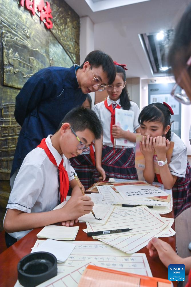 Students take part in a qiaopi writing activity at a museum dedicated to qiaopi in Shantou, south China's Guangdong Province, May 18, 2026. Qiaopi -- letters and remittances sent home by earlier generations of overseas Chinese -- once traveled quietly across oceans, carrying longing and news from distant lives back to families waiting in China. (Photo by Lin Peng/Xinhua)