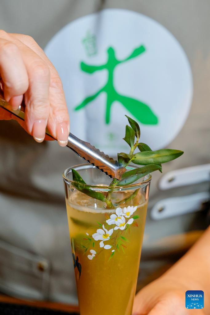 Wang Sun makes new Chinese-style tea drink at the Demingshe tea ceremony vocational school in Huangshan City, east China's Anhui Province, April 24, 2026. In Huangshan, the origin of famous tea varieties Huangshan Maofeng, Taiping Houkui and Qimen Black Tea, Chinese-style tea drink has become a new fashion in recent years. Wang Sun, who set up the Demingshe tea ceremony vocational school in Huangshan City, has led the research and promotion of Chinese-style tea drink since 2021. Appealing to young people's needs for healthy lifestyle, tea drink brands which combine tea and traditional Chinese medicines have become popular among youngsters. (Photo by Shi Yalei/Xinhua)