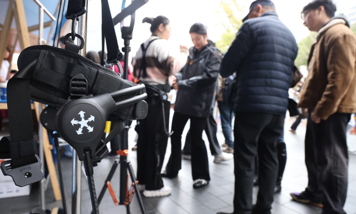 Citizens experience and observe an exoskeleton device in Shanghai on March 21, 2026. Photo: VCG 