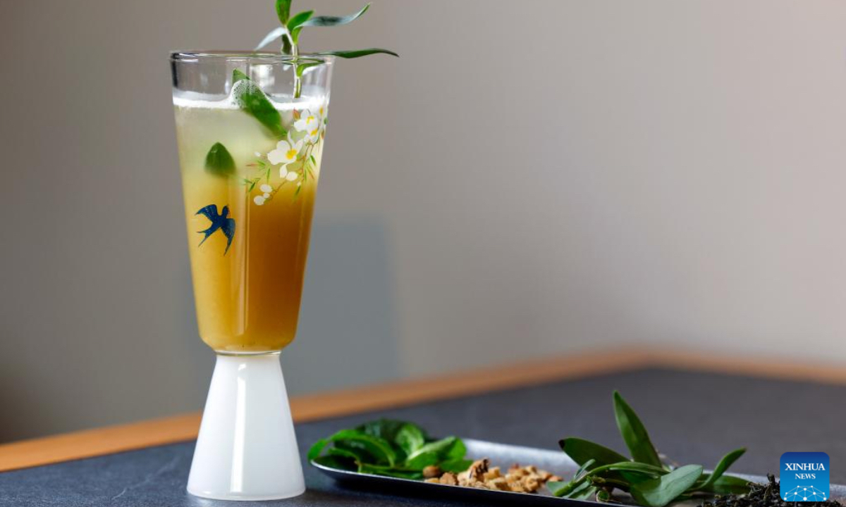 A cup of new Chinese-style tea drink made by Wang Sun is displayed at the Demingshe tea ceremony vocational school in Huangshan City, east China's Anhui Province, April 24, 2026. In Huangshan, the origin of famous tea varieties Huangshan Maofeng, Taiping Houkui and Qimen Black Tea, Chinese-style tea drink has become a new fashion in recent years. Wang Sun, who set up the Demingshe tea ceremony vocational school in Huangshan City, has led the research and promotion of Chinese-style tea drink since 2021. Appealing to young people's needs for healthy lifestyle, tea drink brands which combine tea and traditional Chinese medicines have become popular among youngsters. (Photo by Shi Yalei/Xinhua)