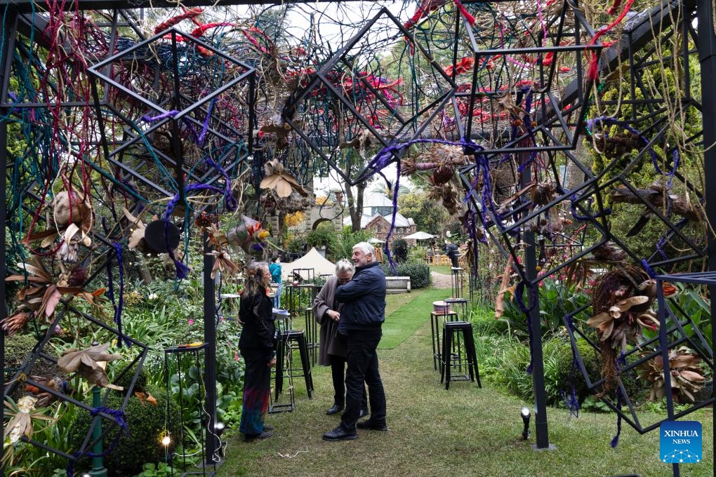 People communicate during the RMB Latitudes Art Fair 2026 at the Shepstone Gardens in Johannesburg, South Africa, May 22, 2026. The art fair, scheduled from May 22 to 24, covers a wide range of artistic fields including painting, sculpture, photography, and design. (Photo: Xinhua)