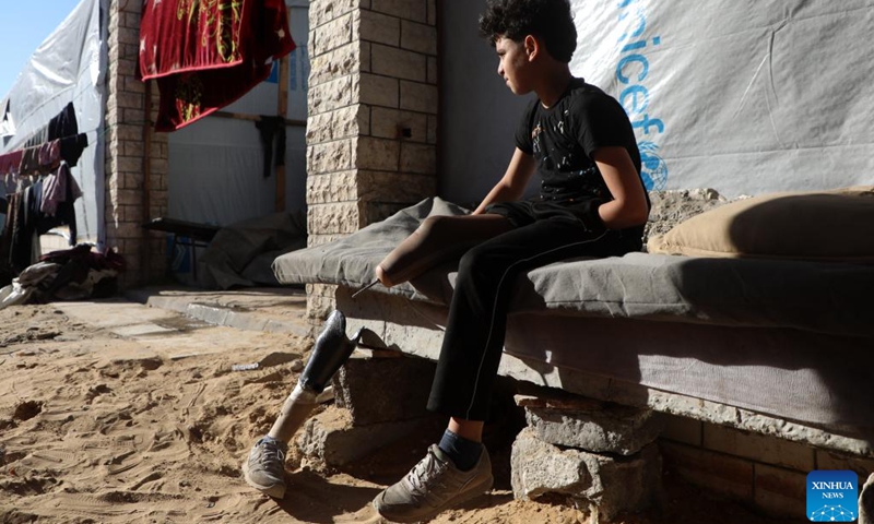 This photo taken on May 22, 2026 shows Akram Sharif al-Fayoumi, a 13-year-old Palestinian teenager, at a temporary tent zone in Gaza City. The boy, from the Shuja'iyya neighborhood of Gaza City, was injured in August of 2024 during an Israeli military operation in eastern Gaza City. He lost his left arm and right leg and remains displaced with his family in western Gaza City. (Photo: Xinhua)