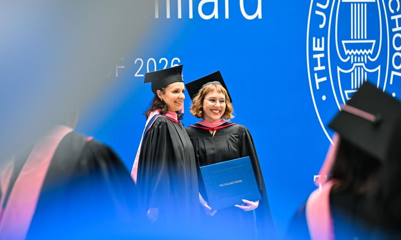Postgraduate students pose for photos after the commencement at the Tianjin Juilliard School in north China's Tianjin Municipality, May 23, 2026. The Tianjin Juilliard School held the commencement for its postgraduate class of 2026 on Saturday. A total of 42 postgraduate students from 14 countries and regions completed their studies here successfully. (Xinhua/Zhao Zishuo)