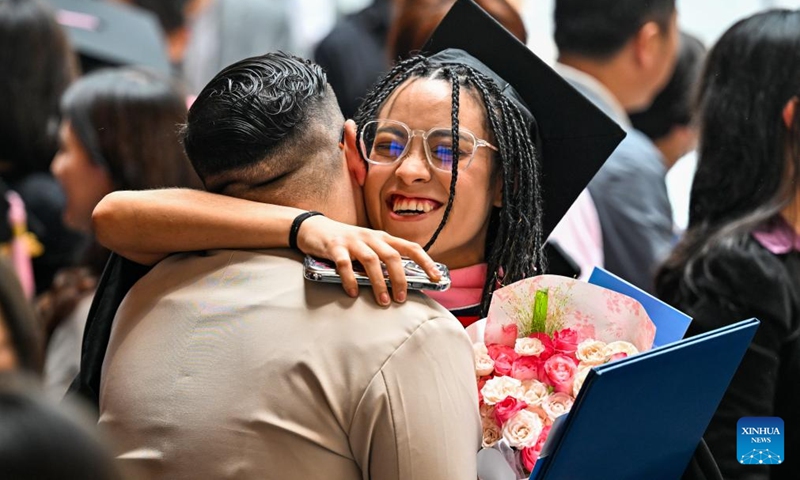 A postgraduate student hugs her friend after the commencement at the Tianjin Juilliard School in north China's Tianjin Municipality, May 23, 2026. The Tianjin Juilliard School held the commencement for its postgraduate class of 2026 on Saturday. A total of 42 postgraduate students from 14 countries and regions completed their studies here successfully. (Xinhua/Zhao Zishuo)