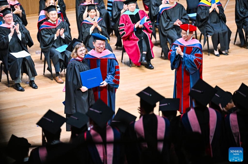 A postgraduate student receives her degree certificate during the commencement at the Tianjin Juilliard School in north China's Tianjin Municipality, May 23, 2026. The Tianjin Juilliard School held the commencement for its postgraduate class of 2026 on Saturday. A total of 42 postgraduate students from 14 countries and regions completed their studies here successfully. (Xinhua/Zhao Zishuo)