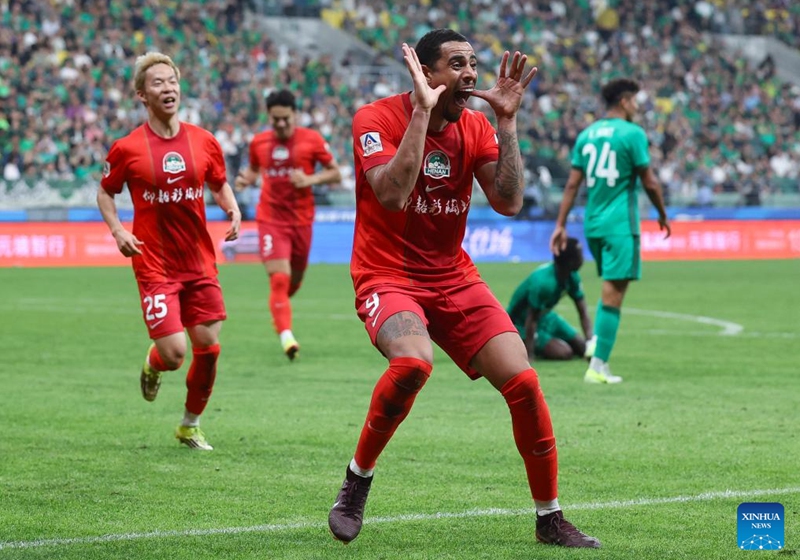Gustavo (R) of Henan FC celebrates a goal during the 14th round match between Beijing Guoan and Henan FC at the 2026 season Chinese Football Super League (CSL) in Beijing, capital of China, May 23, 2026. (Xinhua/Hu Xingyu)
