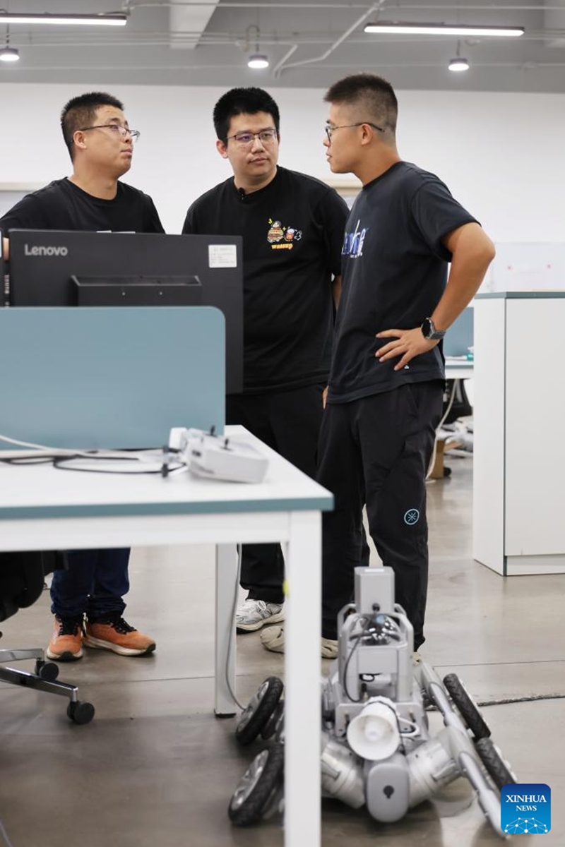 Fu Mingda (C) talks with his colleagues at Galileo (Tianjin) Technology Co., Ltd. in Tianjin, north China, May 22, 2026. Thirty-three-year-old Fu Mingda, an electromagnetic engineering designer at Galileo (Tianjin) Technology Co., Ltd., has his sights set on becoming a technical expert in the motor industry. To that end, he has been tackling key challenges in the independent research and development (R&D) of core robotic components.
After earning his master's degree from Shenyang University of Technology in 2018, Fu relocated to Tianjin to focus on the R&D and design of aviation motors. He later joined Galileo, where he was involved in the in-house development of quadruped robot joint modules from the ground up.
At the time, the company relied on externally procured joint modules that were prone to overheating and damage. Furthermore, these outsourced parts could not meet complex performance requirements, such as performing somersaults, climbing slopes, and carrying heavy loads.
In less than six months, Fu achieved a technological breakthrough. Overseeing the process from initial electromagnetic design to supplier development, assembly, and testing, he drove the project through four major iterations and dozens of minor optimizations. Impressively, the very first prototype reached advanced standards in the industry.
Today, fueled by the rapid growth of China's domestic robotics industry, Fu remains busier than ever. He expressed full confidence that, through continued dedication, he will realize his ambition of becoming a leading technical expert in the motor sector. Photo: Xinhua