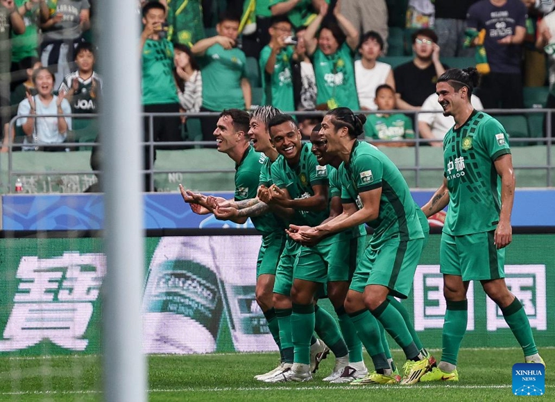 Players of Beijing Guoan celebrate a goal during the 14th round match between Beijing Guoan and Henan FC at the 2026 season Chinese Football Super League (CSL) in Beijing, capital of China, May 23, 2026. (Xinhua/Hu Xingyu)