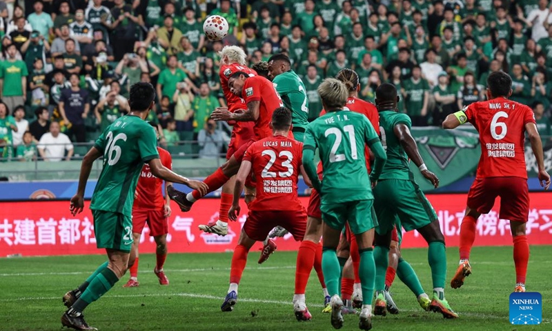 Dawhan (top R) of Beijing Guoan heads to score during the 14th round match between Beijing Guoan and Henan FC at the 2026 season Chinese Football Super League (CSL) in Beijing, capital of China, May 23, 2026. (Xinhua/Hu Xingyu)