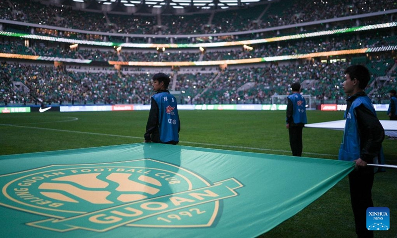 Staff walk into the court before the 14th round match between Beijing Guoan and Henan FC at the 2026 season Chinese Football Super League (CSL) in Beijing, capital of China, May 23, 2026. (Xinhua/Hu Xingyu)