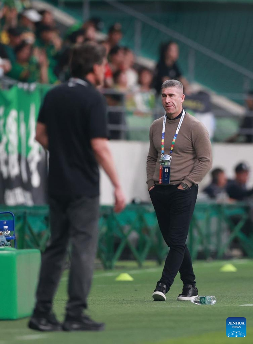 Nick Montgomery (R), head coach of Beijing Guoan, is seen during the 14th round match between Beijing Guoan and Henan FC at the 2026 season Chinese Football Super League (CSL) in Beijing, capital of China, May 23, 2026. (Photo by Ma Zihan/Xinhua)