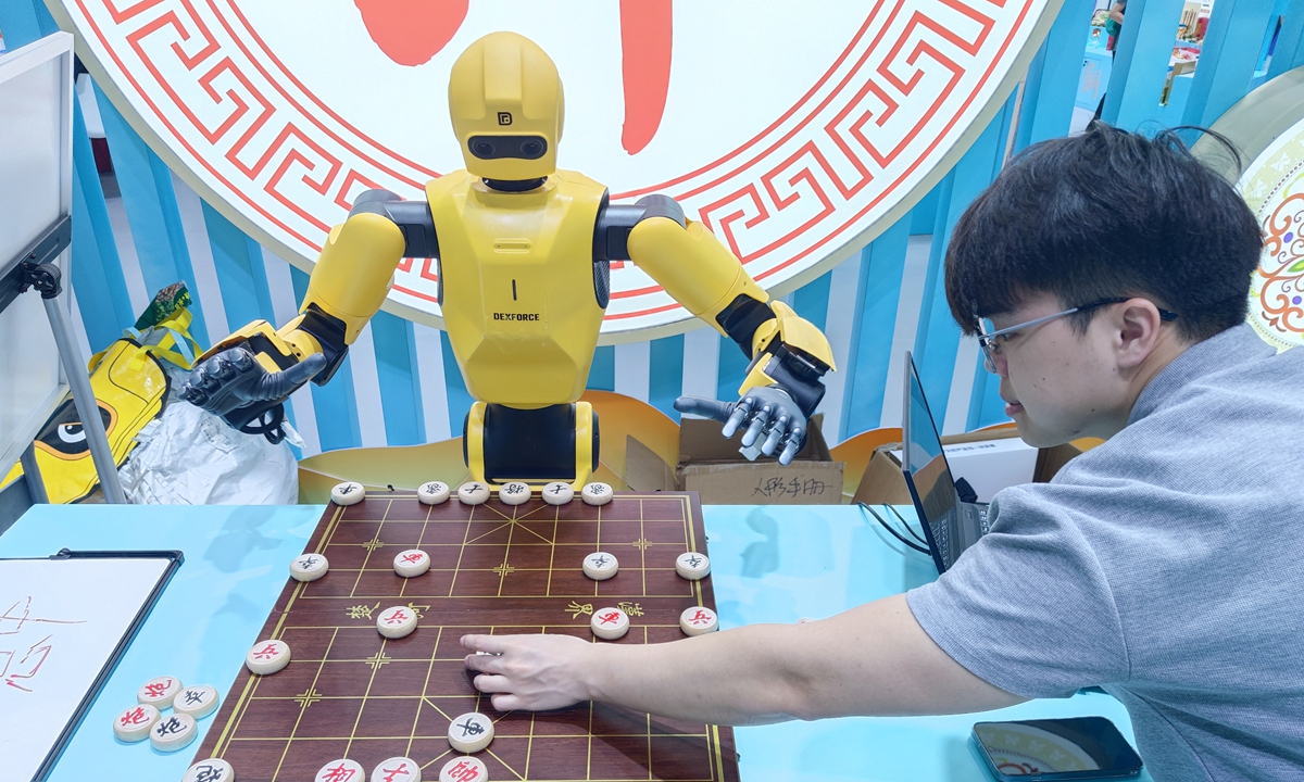 A man plays Chinese chess with a robot at the 22nd China (Shenzhen) International Cultural Industries Fair in Shenzhen, South China's Guangdong Province, on May 24, 2026.