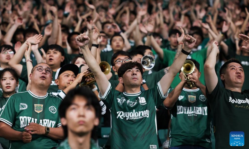 Fans of Beijing Guoan cheer for the team during the 14th round match between Beijing Guoan and Henan FC at the 2026 season Chinese Football Super League (CSL) in Beijing, capital of China, May 23, 2026. (Xinhua/Hu Xingyu)