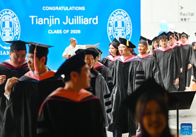 Postgraduate students enter the venue for the commencement at the Tianjin Juilliard School in north China's Tianjin Municipality, May 23, 2026. The Tianjin Juilliard School held the commencement for its postgraduate class of 2026 on Saturday. A total of 42 postgraduate students from 14 countries and regions completed their studies here successfully. (Xinhua/Zhao Zishuo)