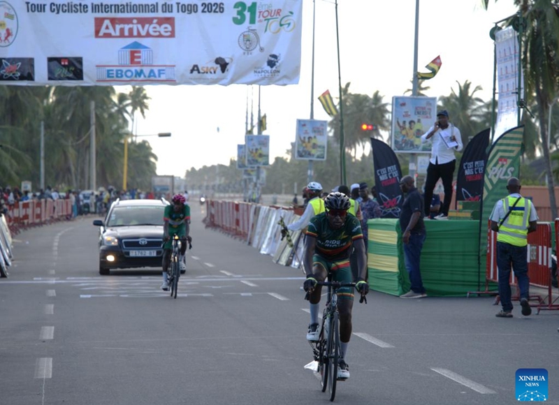 Cyclists cross the finish line of the fourth stage in Lome, Togo, May 23, 2026. The 31st International Cycling Tour of Togo concluded Saturday evening in Lome, the Togolese capital. (Xinhua/Si Yuan)