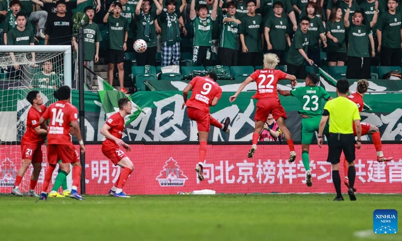 Dawhan (3rd R) of Beijing Guoan heads to score during the 14th round match between Beijing Guoan and Henan FC at the 2026 season Chinese Football Super League (CSL) in Beijing, capital of China, May 23, 2026. (Photo by Ma Zihan/Xinhua)