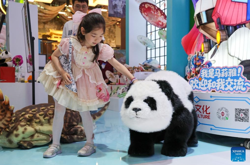 A girl interacts with a robotic panda at the 22nd China (Shenzhen) International Cultural Industries Fair in Shenzhen, south China's Guangdong Province, May 24, 2026. The 22nd China (Shenzhen) International Cultural Industries Fair kicked off on Thursday in the metropolis of Shenzhen.
The five-day event, which highlights cultural industry development, focuses on the digital intelligence empowerment of the industry and the cultivation of new quality productive forces, gathering domestic and foreign high-end cultural industry resources and innovation elements. Photo: Xinhua