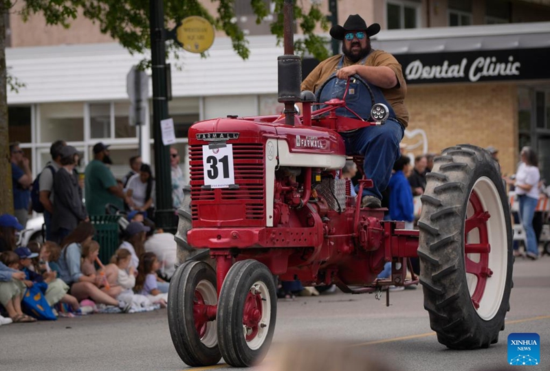 A man drives a tractor on the street during the Ladner May Days parade in Ladner, British Columbia, Canada, May 24, 2026. (Photo by Liang Sen/Xinhua)