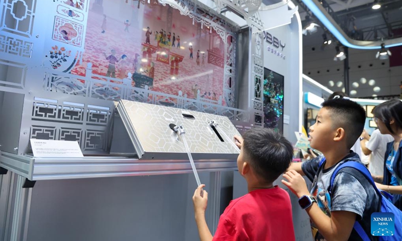 Children try a digital shadow puppet show at the 22nd China (Shenzhen) International Cultural Industries Fair in Shenzhen, south China's Guangdong Province, May 24, 2026. The 22nd China (Shenzhen) International Cultural Industries Fair kicked off on Thursday in the metropolis of Shenzhen.
The five-day event, which highlights cultural industry development, focuses on the digital intelligence empowerment of the industry and the cultivation of new quality productive forces, gathering domestic and foreign high-end cultural industry resources and innovation elements. Photo: Xinhua