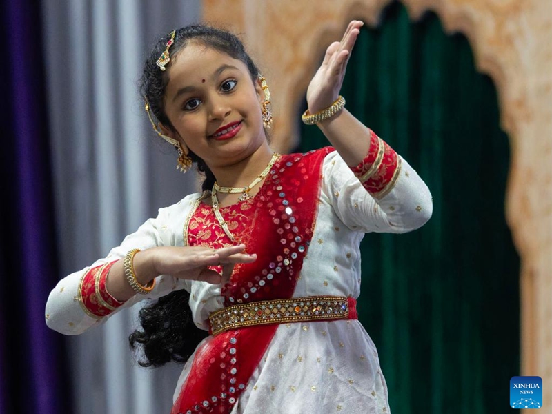 A girl dances during the 2026 Carassauga Festival of Cultures in Mississauga, Ontario, Canada, May 23, 2026. The two-day annual cultural event kicked off here on Saturday, featuring diverse cuisine, stage shows and interactive experiences. (Photo by Zou Zheng/Xinhua)