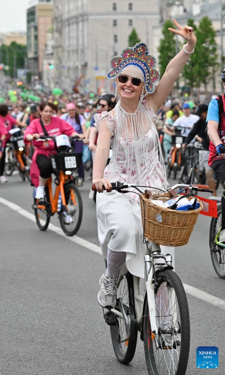 A woman rides a bicycle during a spring bicycle festival in Moscow, Russia, May 24, 2026. The spring bicycle festival aimed to promote an eco-friendly and healthy lifestyle. (Photo by Alexander Zemlianichenko Jr/Xinhua)