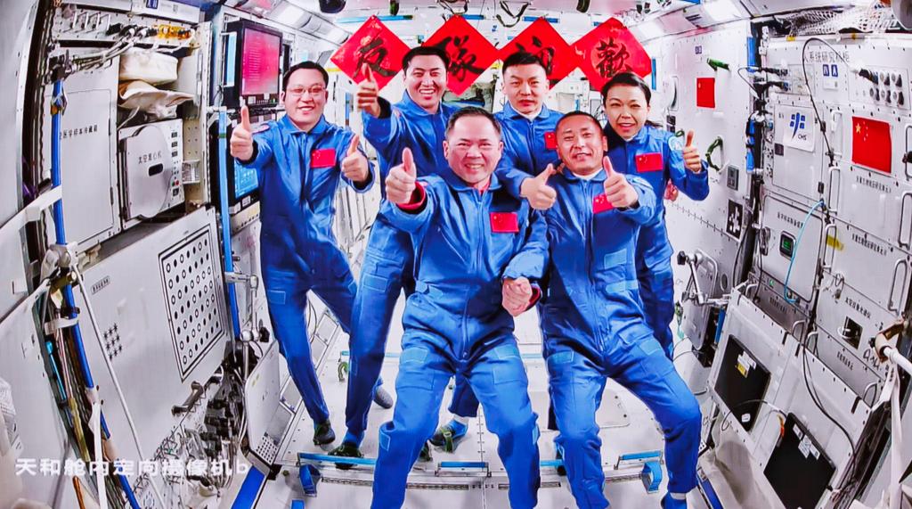 This image captured at Beijing Aerospace Control Center on May 25, 2026 shows a group picture of the crew of Shenzhou-21 and Shenzhou-23 spaceships. The three astronauts aboard China's Shenzhou-23 spaceship have entered the Tiangong space station and met with another astronaut trio on Monday, starting a new round of in-orbit crew handover. The Shenzhou-21 crew aboard Tiangong opened the hatch at 5:13 a.m. (Beijing Time) and welcomed the new arrivals, according to the China Manned Space Agency (CMSA). The two crews then took group pictures for the eighth space get-together in China's aerospace history. They will conduct handover work aboard the space station, the CMSA said. Photo: Xinhua