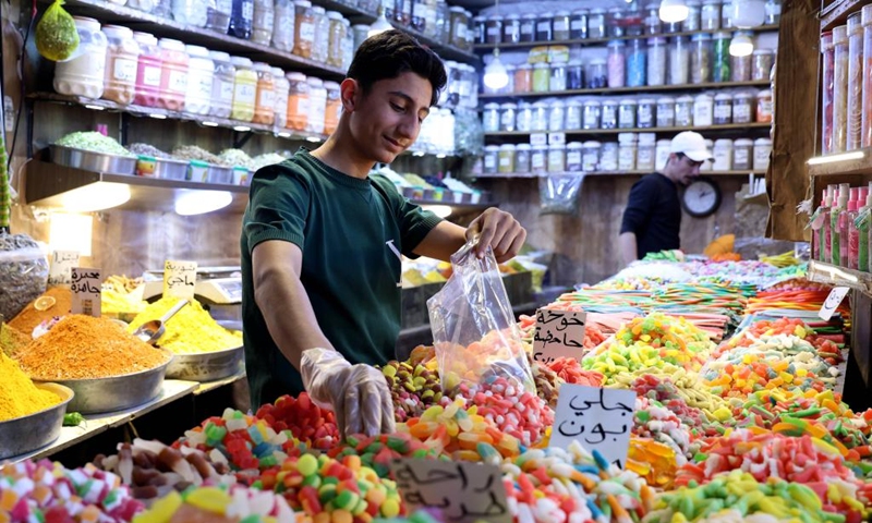 Sweets for sale are pictured ahead of the Muslim festival of Eid al-Adha, or the Feast of Sacrifice, in Damascus, Syria, May 24, 2026. (Photo by Ammar Safarjalani/Xinhua)