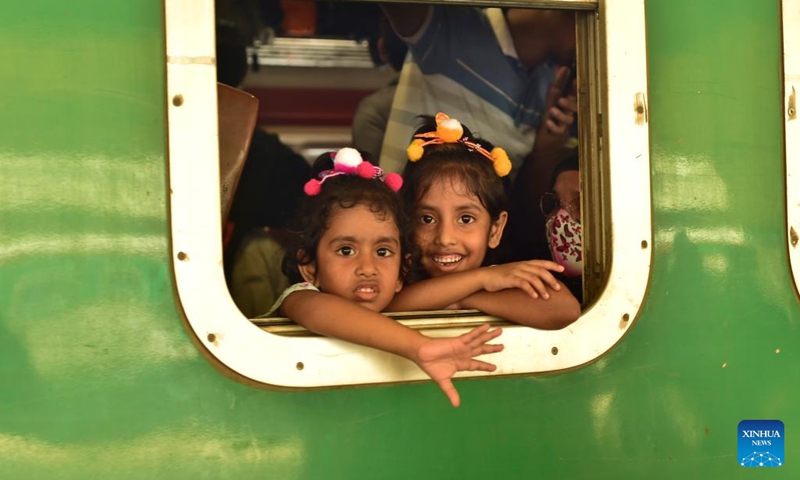 Children are pictured aboard a train during the Eid al-Adha travel rush at Kamalapur Railway Station in Dhaka, Bangladesh, May 24, 2026. As Eid al-Adha approaches, many people from Dhaka have streamed out of the city to join the festival with their kith and kin in hometowns. (Photo by Habibur Rahman/Xinhua)