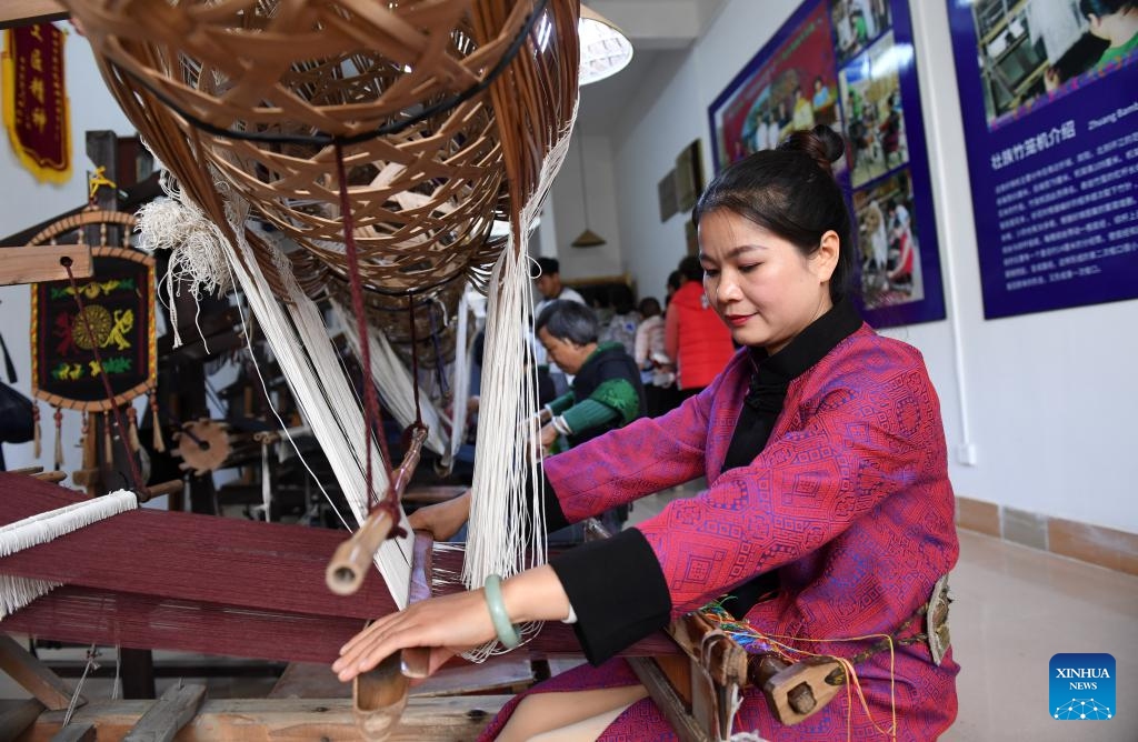 A woman weaves Zhuang brocade at an inheritance base of intangible cultural heritage in Binyang County, south China's Guangxi Zhuang Autonomous Region, Nov. 24, 2018. (Photo: Xinhua)