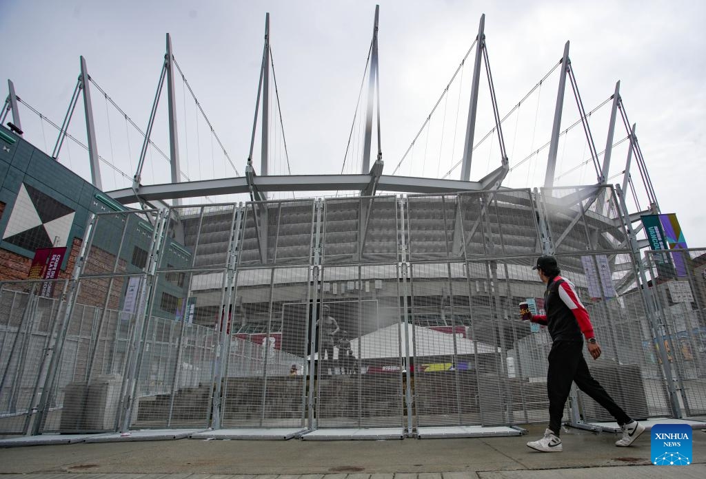 A man walks past fencing surrounding BC Place for the FIFA World Cup 2026 in Vancouver, Canada, on May 26, 2026. (Photo: Xinhua)