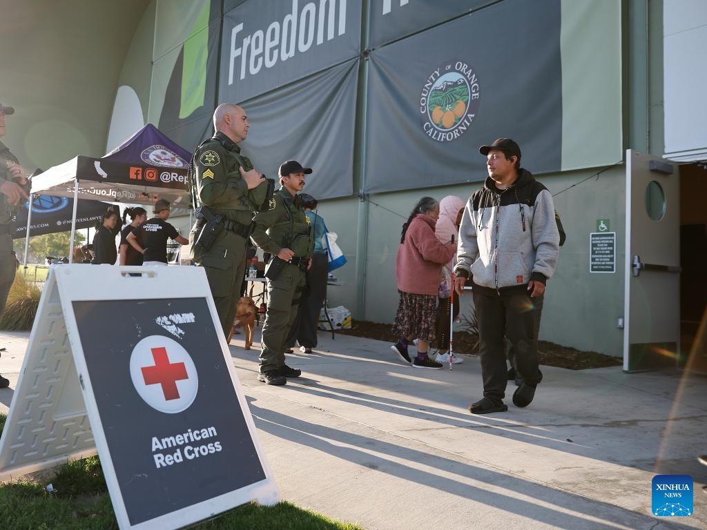 Orange County Sheriff deputies stand guard at the entrance to an emergency shelter in Fountain Valley, Orange County, California, the United States, on May 24, 2026. California authorities said on Sunday that a potential crack was found in a damaged industrial tank containing volatile chemicals in Orange County as emergency crews raced to prevent the tank from rupturing or exploding. Authorities pointed out that the situation was still dangerously volatile, and evacuation orders remain in place for more than 50,000 residents in six Orange County cities, namely Garden Grove, Cypress, Stanton, Anaheim, Buena Park and Westminster. (Photo: Xinhua)